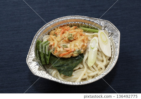 Nabeyaki tempura udon in an aluminum pot before cooking 136492775