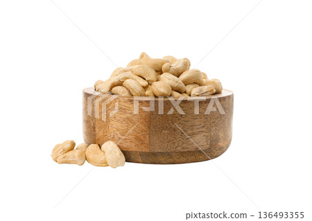 Cashews in a wooden bowl on a white surface, PNG 136493355