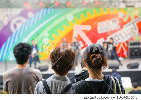 People watching a band perform on stage at a school festival People watching a band perform on stage at a school festival 136493675