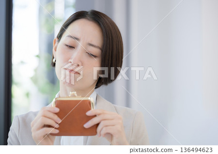 The sad and troubled image of working but not having any money (being broke). Prices are so high, it's tough - will we be in the red again this month? 136494623