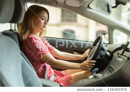 Young woman sitting in car Young woman sitting in car 136495978