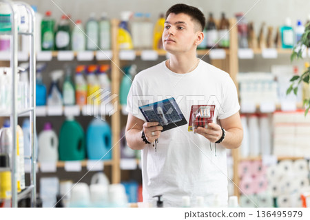 Young man choosing razor in store 136495979