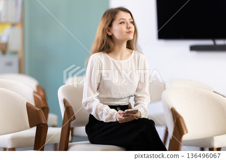 Girl student pupil attends class in study room, listens to lecture 136496067