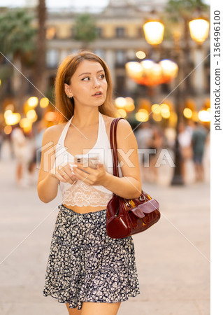 Woman walking around Barcelona, she has visited Placa real and plans to spend the evening in bars and restaurants with friends Woman walking around Barcelona, she has visited Placa real and plans to spend the evening in bars and restaurants with friends 136496100