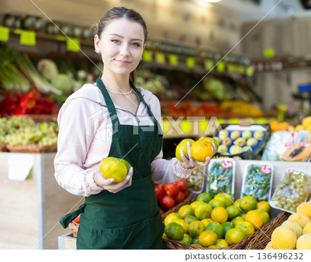 Portrait of girl working in grocery shop as job experience, selling lime 136496232