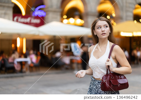 Young woman walking in Royal Square (Placa Real) in Barcelona Young woman walking in Royal Square (Placa Real) in Barcelona 136496242