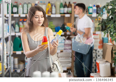 woman chooses a repellent against the background of the buyer 136496345