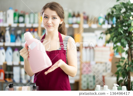 Saleswoman offers to buy detergent in supermarket 136496417