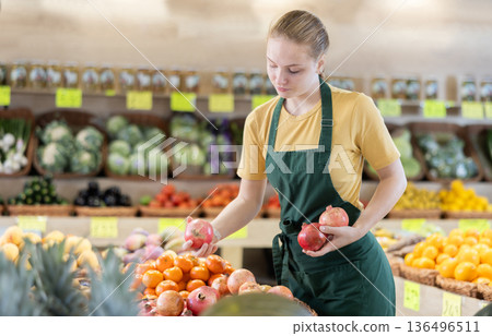 Young woman seller lays out grenades on the counter Young woman seller lays out grenades on the counter 136496511