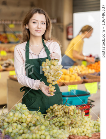 woman shopping assistant selling grape in supermarket woman shopping assistant selling grape in supermarket 136496537