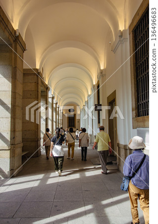 Tourists crossing the cloisters of Toledo Cathedral Tourists crossing the cloisters of Toledo Cathedral 136496683