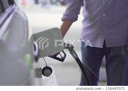 Image of a person refueling a car (self) Image of a person refueling a car (self) 136497072