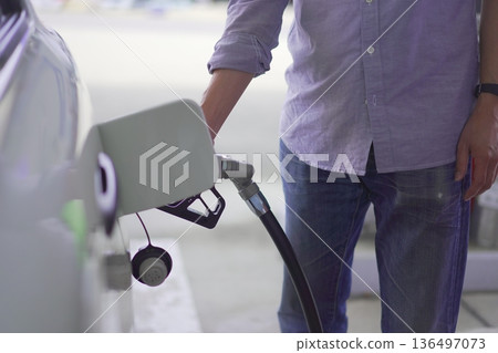 Image of a person refueling a car (self) Image of a person refueling a car (self) 136497073
