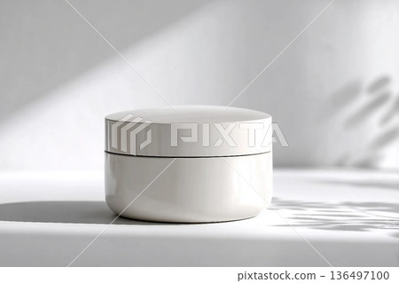 Blank white cream jar on a white background with soft, natural light and shadows. An elegant and minimalist mockup for beauty or skincare products. Blank white cream jar on a white background with soft, natural light and shadows. An elegant and minimalist mockup for beauty or skincare products. 136497100