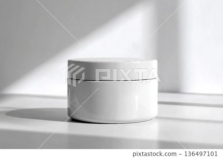 Blank white cream jar on a white background with soft, natural light and shadows. An elegant and minimalist mockup for beauty or skincare products. Blank white cream jar on a white background with soft, natural light and shadows. An elegant and minimalist mockup for beauty or skincare products. 136497101
