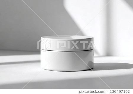 Blank white cream jar on a white background with soft, natural light and shadows. An elegant and minimalist mockup for beauty or skincare products. Blank white cream jar on a white background with soft, natural light and shadows. An elegant and minimalist mockup for beauty or skincare products. 136497102