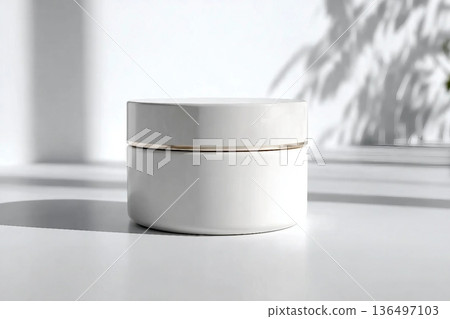 Blank white cream jar on a white background with soft, natural light and shadows. An elegant and minimalist mockup for beauty or skincare products. Blank white cream jar on a white background with soft, natural light and shadows. An elegant and minimalist mockup for beauty or skincare products. 136497103