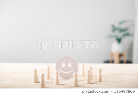 Feedback concept illustrates positive customer satisfaction with happy face icon surrounded by wooden figures for service evaluation and quality rating 136497669