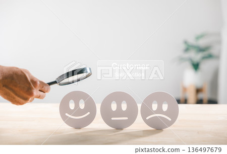Customer satisfaction business quality survey using magnifying glass focusing happy face rating highlights service excellence and positive client feedback evaluation 136497679