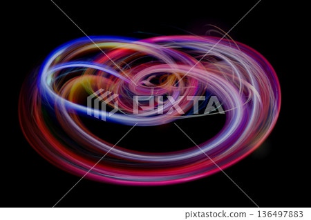 A vortex of colorful rays floating on a black background A vortex of colorful rays floating on a black background 136497883