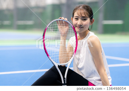 A woman playing tennis A woman playing tennis 136498054