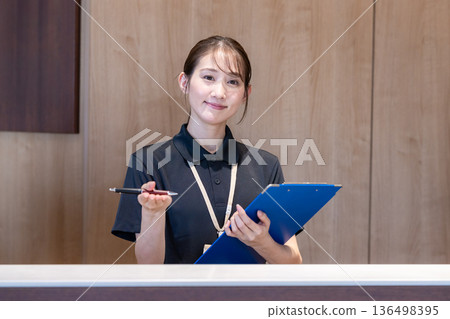 Woman at reception Woman at reception 136498395