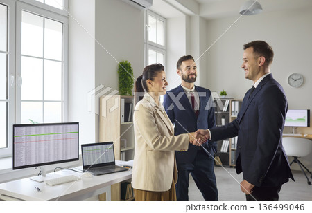 Business team handshake in modern office during meeting and partnership deal 136499046