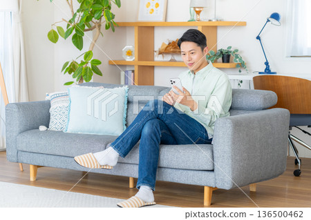 A man operating a smartphone A man operating a smartphone 136500462