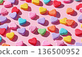 Playful Valentine's background: scattered conversation heart candies in bright colors against a light pink background. 136500952