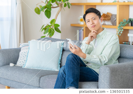 A man operating a smartphone 136501535