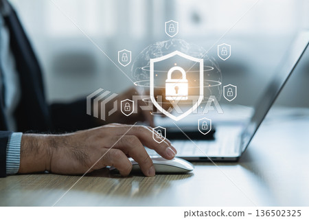 Modern cybersecurity concept showcasing hands using laptop with digital padlock icons representing data protection and online security awareness in the workplace Modern cybersecurity concept showcasing hands using laptop with digital padlock icons representing data protection and online security awareness in the workplace 136502325