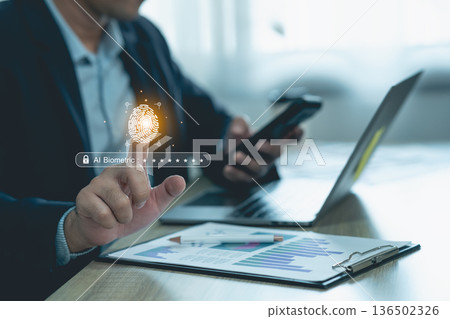 Modern Businessman Using Fingerprint Recognition Technology for Security and Authentication at Workplace with Laptop and Smartphone Modern Businessman Using Fingerprint Recognition Technology for Security and Authentication at Workplace with Laptop and Smartphone 136502326