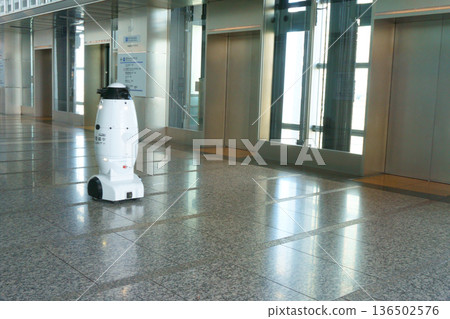 Security robot passing in front of the elevator Security robot passing in front of the elevator 136502576