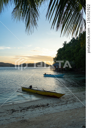 Boat at sunset on Bolilanga Island, Togian archipelago, Sulawesi, Indonesia Boat at sunset on Bolilanga Island, Togian archipelago, Sulawesi, Indonesia 136502922
