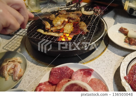 Grilling meat on a charcoal grill Grilling meat on a charcoal grill 136503048