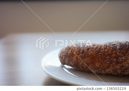 Traditional xuixo pastry from Girona on white plate with copy space Traditional xuixo pastry from Girona on white plate with copy space 136503229