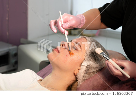 Cosmetology facial treatment with applicator during skincare procedure Cosmetology facial treatment with applicator during skincare procedure 136503307