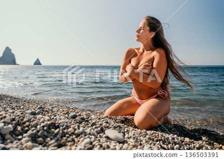 Woman in Pink Bikini on a Pebble Beach 136503391