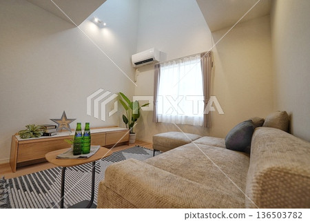 Living room with an open ceiling and stylish sofa Living room with an open ceiling and stylish sofa 136503782