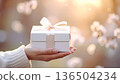 Women's hand with gifts 136504234