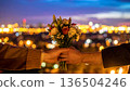 Handing over a bouquet of flowers over the night view 136504246