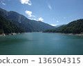 A crystal clear lake surrounded by mountains 136504315