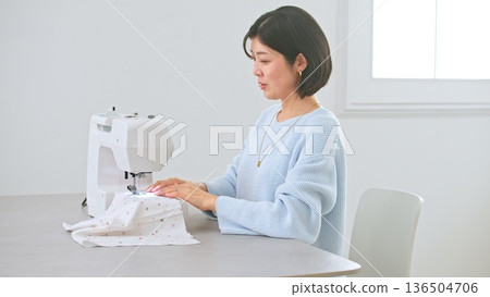 Sewing machine woman image 136504706
