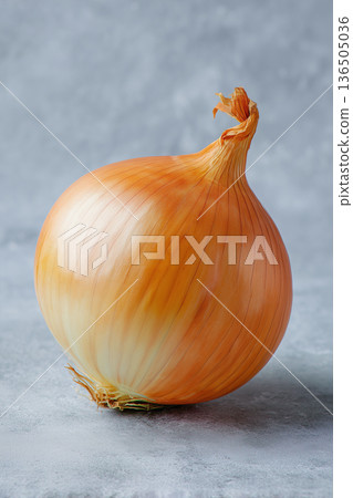 Fresh orange onion on a gray surface ready for cooking or eating 136505036