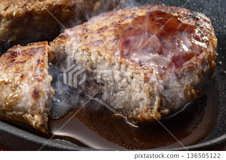 Delicious hamburger steak on a hot plate Delicious hamburger steak on a hot plate 136505122