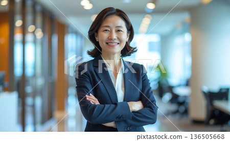 Smiling Japanese woman with arms crossed, business image Smiling Japanese woman with arms crossed, business image 136505668