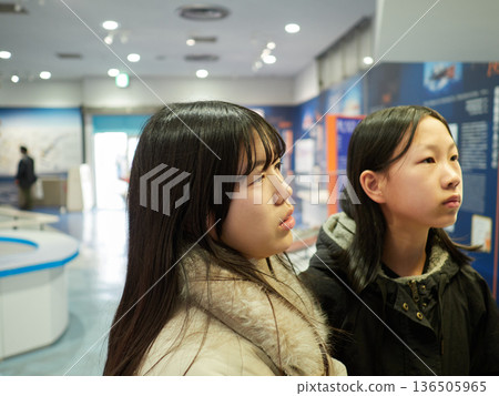 Two junior high school sisters visiting the exhibition hall during winter break Two junior high school sisters visiting the exhibition hall during winter break 136505965