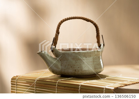 Japanese Ceramic Teapot on Bamboo Mat with Copy Space 136506150