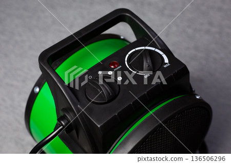 Temperature and heater mode controller. Light indicates fan heater power status and power modes. Setting temperature for warming cold room. Device for heating room. Increasing the temperature 136506296