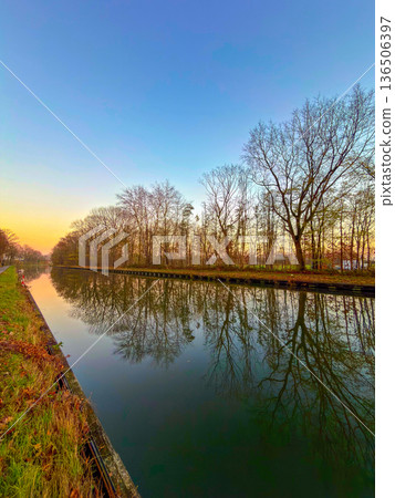 Rijkevorsel, Antwerpse Kempen, Belgium, Golden hour canal with mirrored trees photographers pause 136506397